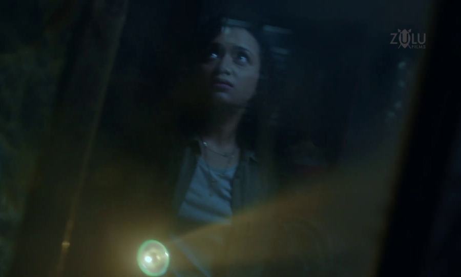 Pranali holding a torch in the Airtel Horror commercial.